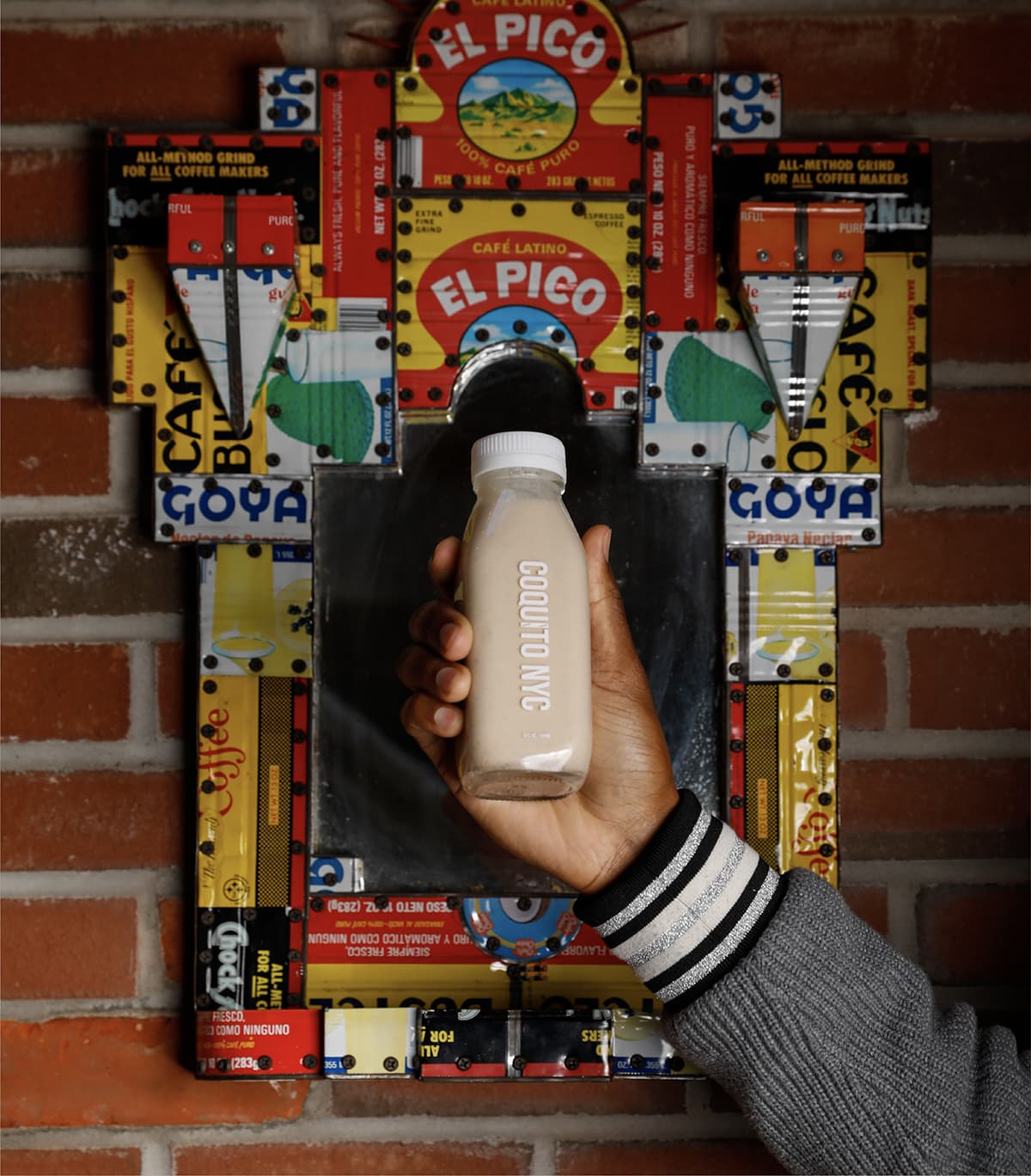 Coquito bottle being held